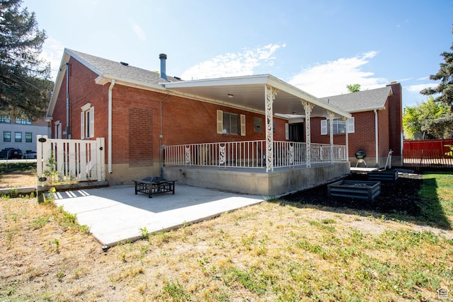 129 N 100 E, Ephraim, UT 84627 - rear view of house with brick siding, a patio area, and a lawn