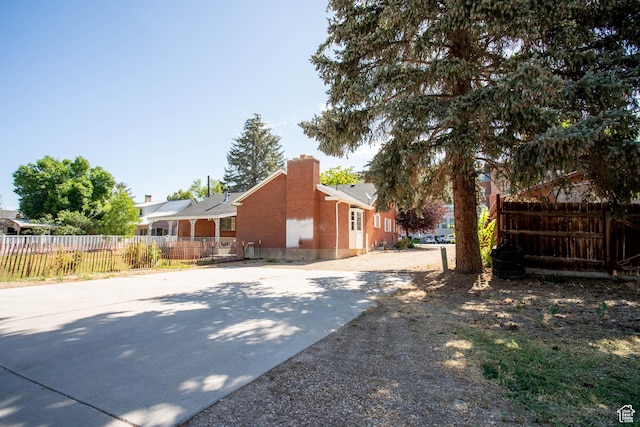 129 N 100 E, Ephraim, UT 84627 - view of side of property featuring a chimney, brick siding, and driveway