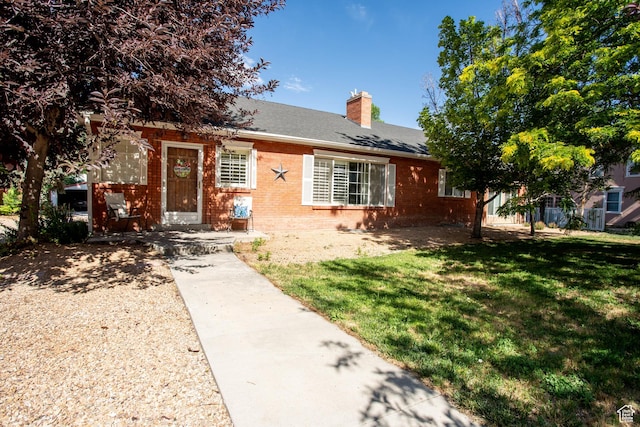 129 N 100 E, Ephraim, UT 84627 - view of front of home featuring brick siding, a chimney, a front yard, and roof with shingles