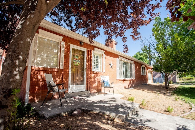 129 N 100 E, Ephraim, UT 84627 - view of front of house featuring a chimney, brick siding, and a patio