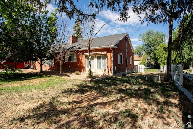 129 N 100 E, Ephraim, UT 84627 - rear view of property featuring brick siding and a chimney