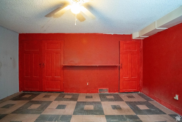 129 N 100 E, Ephraim, UT 84627 - empty room featuring a textured ceiling, ceiling fan, and tile patterned floors