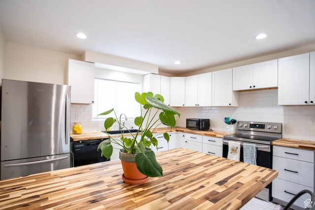 129 N 100 E, Ephraim, UT 84627 - kitchen with butcher block counters, black appliances, white cabinets, tasteful backsplash, and recessed lighting