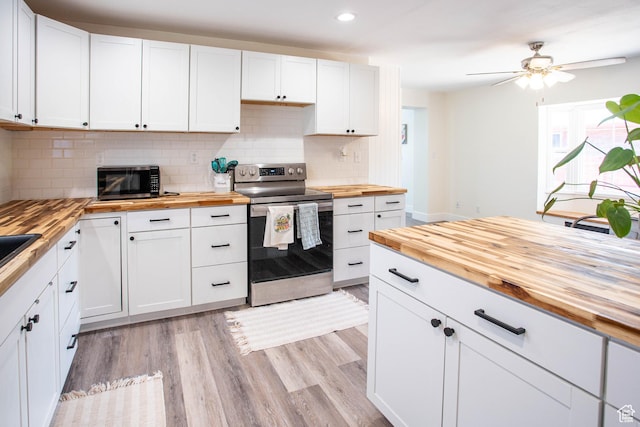 129 N 100 E, Ephraim, UT 84627 - kitchen featuring wood counters, appliances with stainless steel finishes, backsplash, white cabinetry, and a ceiling fan