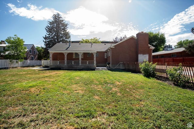 129 N 100 E, Ephraim, UT 84627 - back of house featuring a fenced backyard, a wooden deck, a chimney, and brick siding