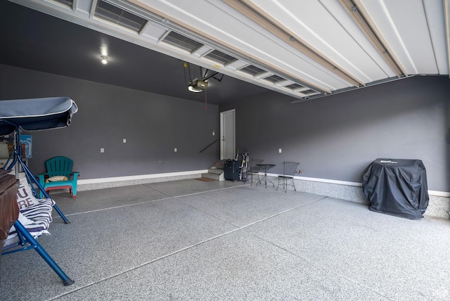 5198 W Courtly Ln, Herriman, UT 84096 - garage with a garage door opener and baseboards
