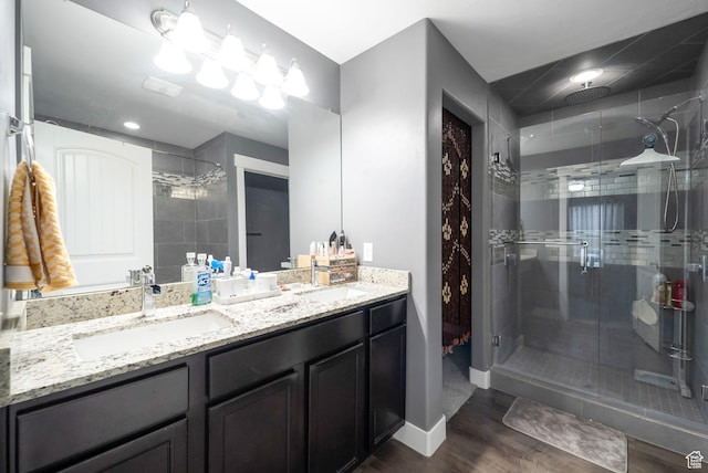 5198 W Courtly Ln, Herriman, UT 84096 - bathroom featuring a shower stall, double vanity, and wood finished floors