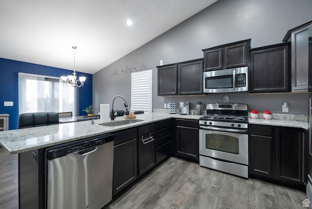 5198 W Courtly Ln, Herriman, UT 84096 - kitchen featuring appliances with stainless steel finishes, lofted ceiling, a peninsula, a chandelier, and light wood-style floors