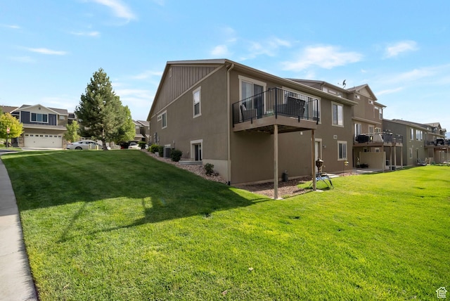 5198 W Courtly Ln, Herriman, UT 84096 - view of side of home with a residential view, a yard, stucco siding, and a balcony