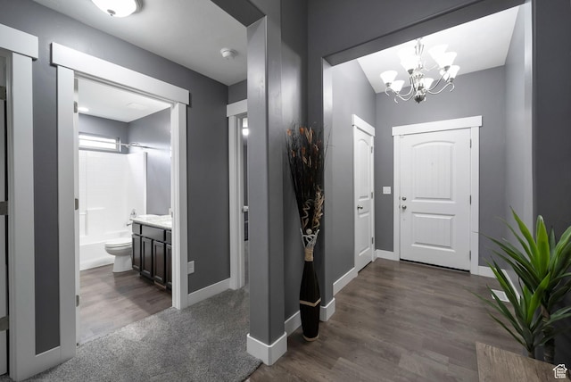 5198 W Courtly Ln, Herriman, UT 84096 - entryway with a chandelier and dark wood-type flooring