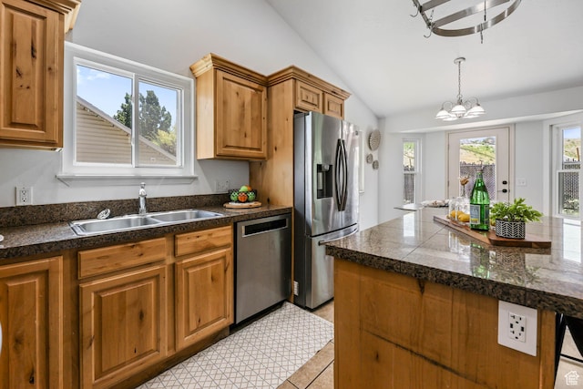 6228 S Waller Ln, West Jordan, UT 84081 - kitchen with appliances with stainless steel finishes, vaulted ceiling, a chandelier, tile countertops, and brown cabinetry
