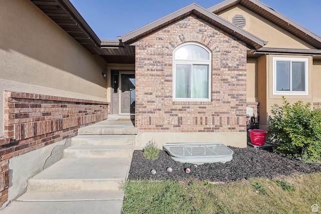 6228 S Waller Ln, West Jordan, UT 84081 - view of exterior entry with stucco siding and brick siding