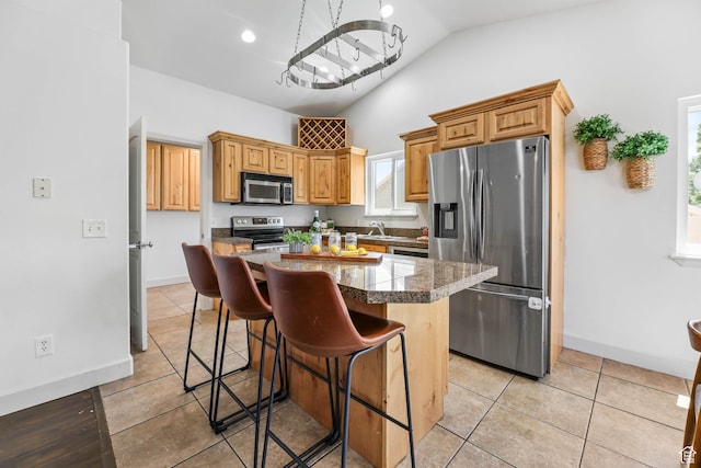 6228 S Waller Ln, West Jordan, UT 84081 - kitchen with appliances with stainless steel finishes, vaulted ceiling, a breakfast bar area, a chandelier, and light tile patterned flooring