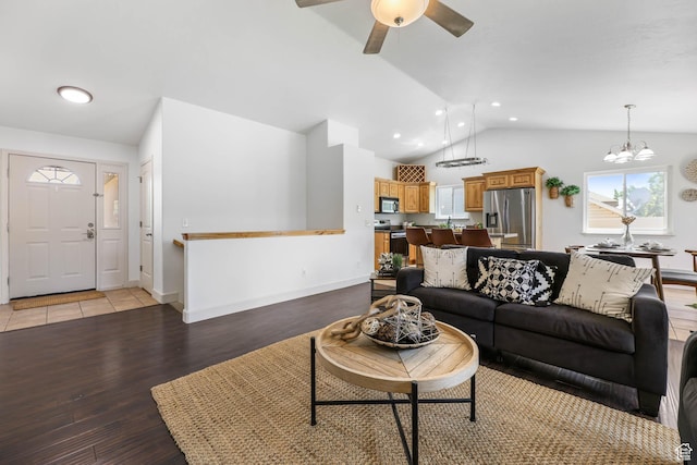 6228 S Waller Ln, West Jordan, UT 84081 - living room with vaulted ceiling, light wood-style floors, a ceiling fan, a chandelier, and recessed lighting
