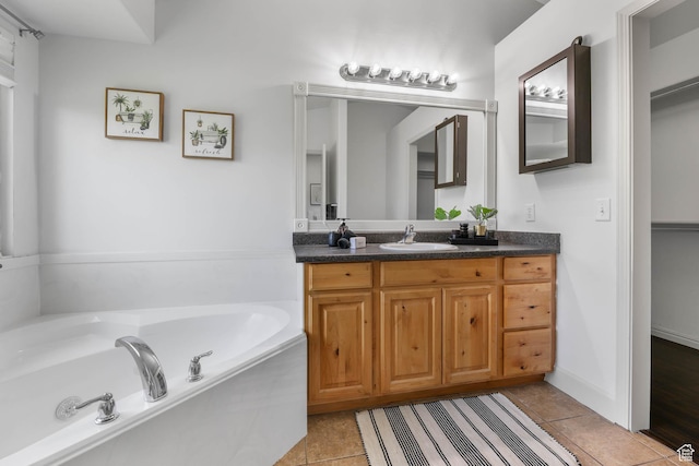6228 S Waller Ln, West Jordan, UT 84081 - bathroom featuring vanity, a garden tub, and tile patterned flooring
