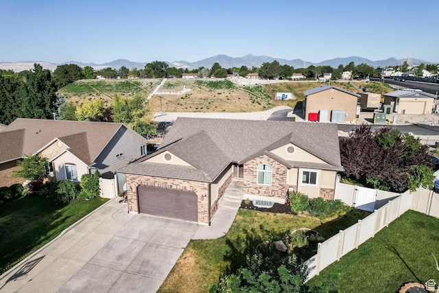 6228 S Waller Ln, West Jordan, UT 84081 - view of front facade featuring a garage, driveway, stone siding, and a mountain view