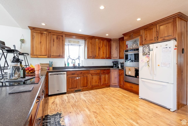 1663 W 2500 N, Vernal, UT 84078 - kitchen featuring stainless steel appliances, brown cabinets, light wood-style flooring, and recessed lighting