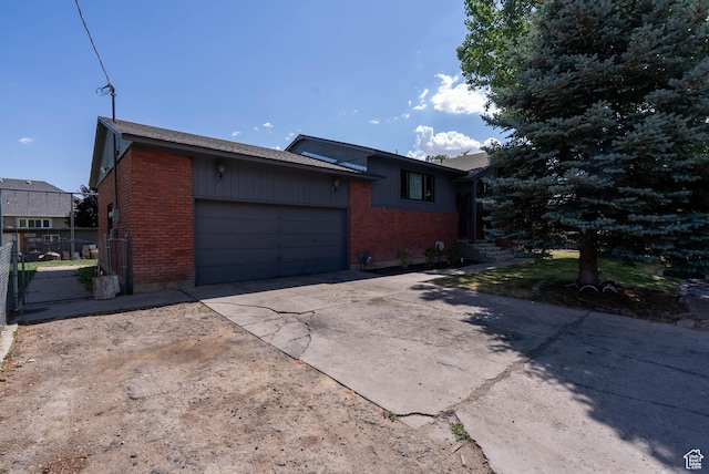 1663 W 2500 N, Vernal, UT 84078 - view of home's exterior featuring brick siding, an attached garage, and driveway