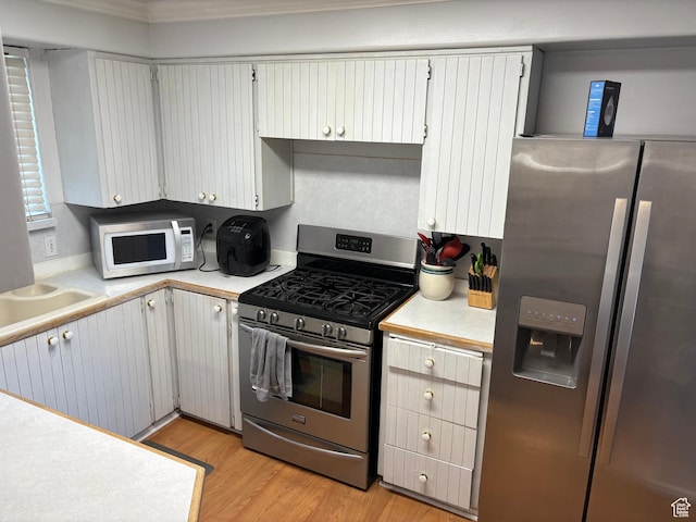 4208 S 4205 W, West Valley City, UT 84120 - kitchen featuring appliances with stainless steel finishes, light countertops, and light wood-type flooring