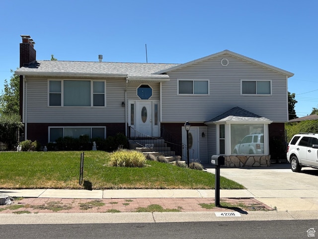 4208 S 4205 W, West Valley City, UT 84120 - bi-level home with a chimney, a front lawn, roof with shingles, and entry steps