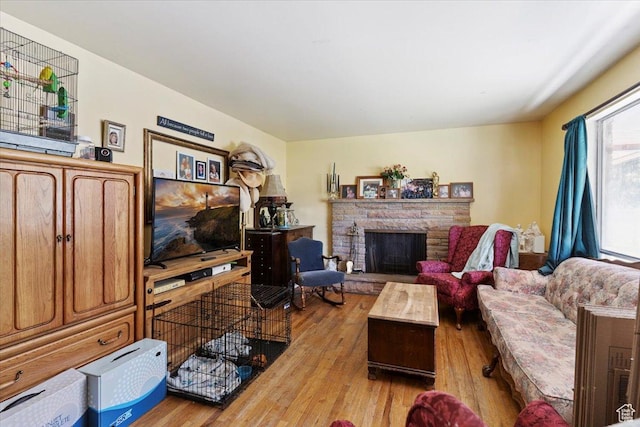 2262 W 2300 N, Clinton, UT 84015 - living room featuring wood finished floors and a fireplace