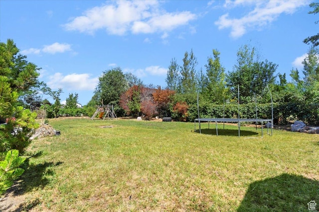 2262 W 2300 N, Clinton, UT 84015 - view of grassy yard with a trampoline and a playground