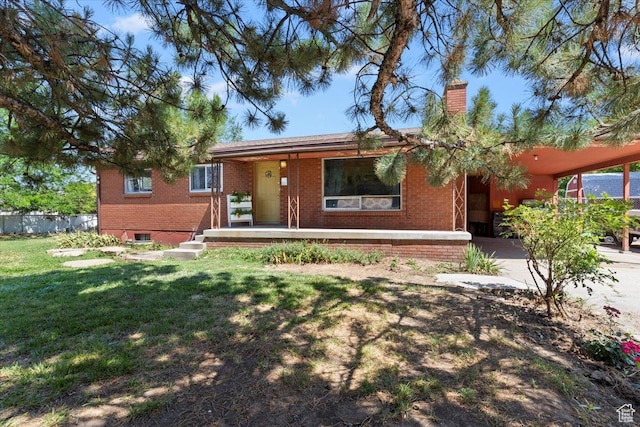 2262 W 2300 N, Clinton, UT 84015 - single story home with brick siding, a carport, a front yard, a chimney, and covered porch