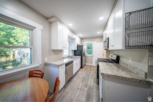 252 E 1000 N, Logan, UT 84321 - kitchen featuring stainless steel appliances, light wood-type flooring, white cabinets, recessed lighting, and light stone counters