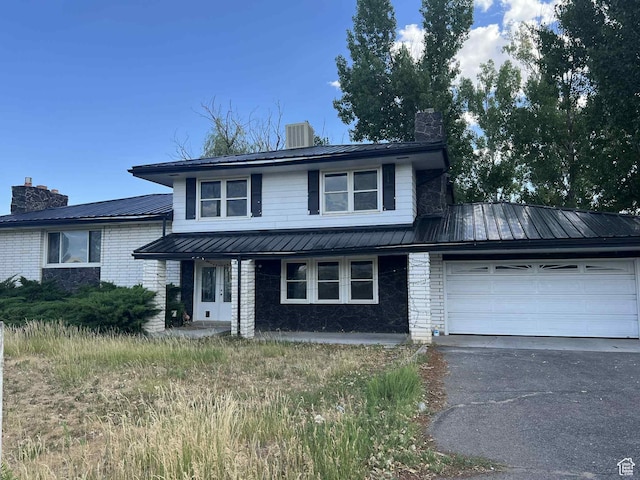 736 E 1500 N, Vernal, UT 84078 - view of front of property with a chimney, brick siding, a garage, and a metal roof