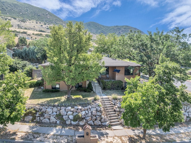1834 N 200 E, Centerville, UT 84014 - view of front of property with stairway, a mountain view, and brick siding
