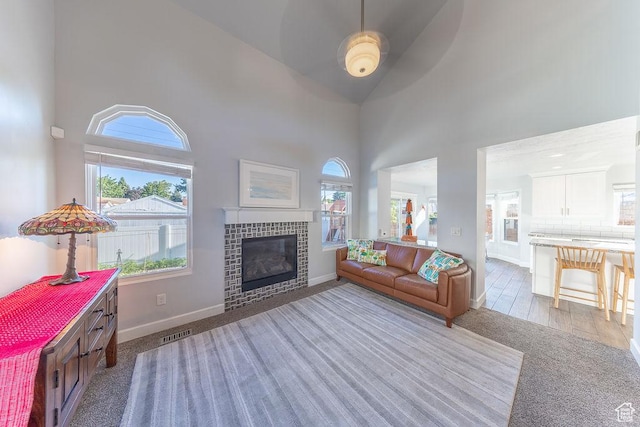 788 E 8230 S, Sandy, UT 84094 - living area featuring a towering ceiling, plenty of natural light, and a tile fireplace