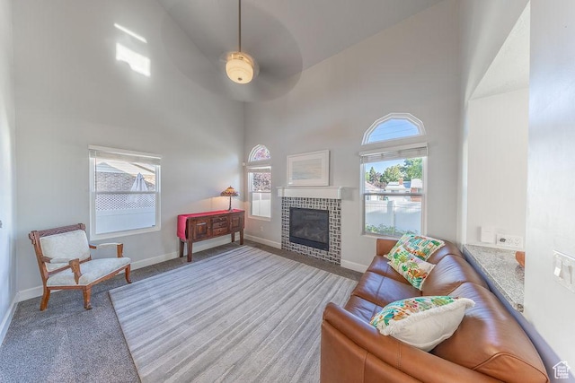 788 E 8230 S, Sandy, UT 84094 - living room featuring a high ceiling, a ceiling fan, a tile fireplace, and carpet floors