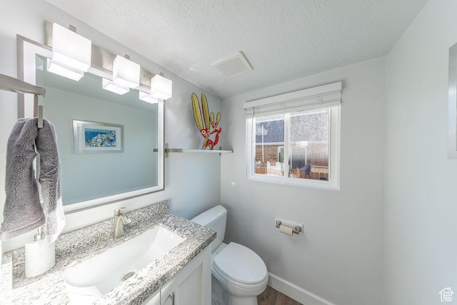 788 E 8230 S, Sandy, UT 84094 - half bath featuring vanity, a textured ceiling, and wood finished floors
