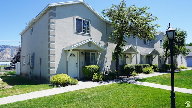 85 Hampton Pl N, Logan, UT 84341 - traditional-style home with stucco siding and a front lawn