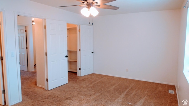 85 Hampton Pl N, Logan, UT 84341 - unfurnished bedroom featuring light carpet, a walk in closet, and ceiling fan