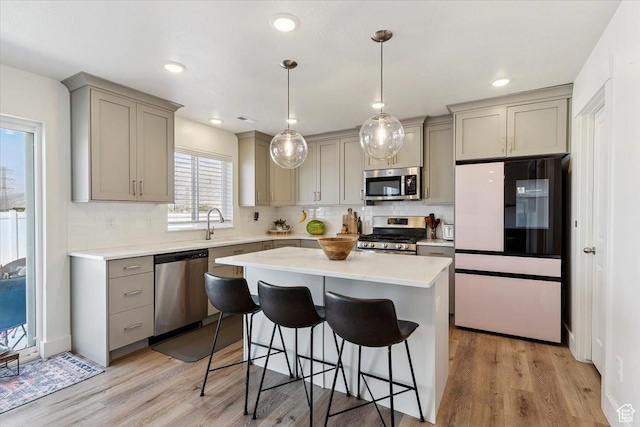 3380 W 3275 N, Plain City, UT 84404 - kitchen with stainless steel appliances, gray cabinetry, a kitchen bar, tasteful backsplash, and recessed lighting