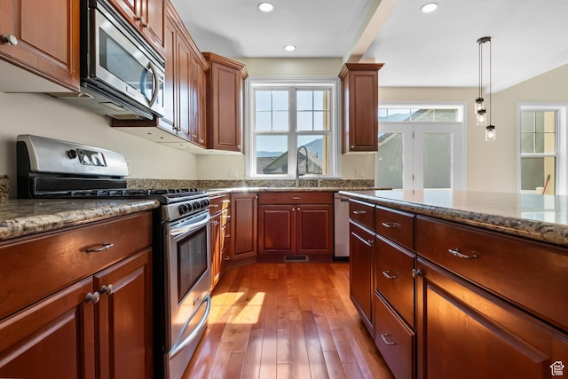 889 S Sego Lily Way, Mapleton, UT 84664 - kitchen featuring stainless steel appliances, wood-type flooring, hanging light fixtures, dark stone countertops, and recessed lighting