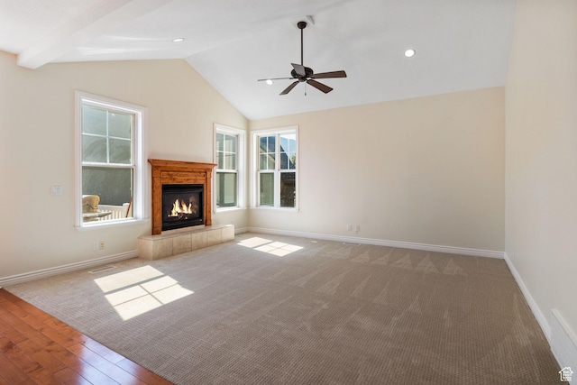 889 S Sego Lily Way, Mapleton, UT 84664 - unfurnished living room with a tile fireplace, ceiling fan, lofted ceiling, carpet flooring, and wood finished floors