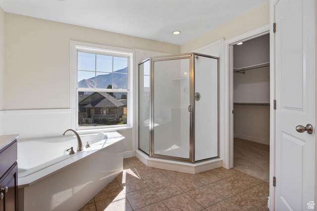 889 S Sego Lily Way, Mapleton, UT 84664 - bathroom featuring a stall shower, a mountain view, a bath, a spacious closet, and tile patterned flooring