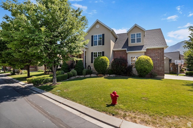 889 S Sego Lily Way, Mapleton, UT 84664 - traditional-style home with brick siding, a front lawn, and roof with shingles