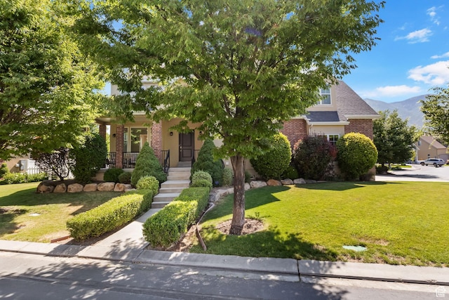 889 S Sego Lily Way, Mapleton, UT 84664 - obstructed view of property with brick siding, a front lawn, and a mountain view