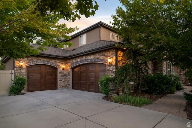 292 E Clubview Ln, Lehi, UT 84043 - view of front of property featuring stone siding, an attached garage, driveway, and stucco siding