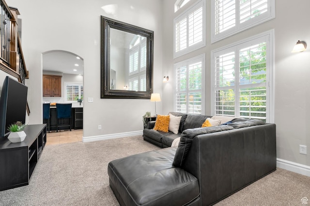 292 E Clubview Ln, Lehi, UT 84043 - living area featuring a towering ceiling, light carpet, healthy amount of natural light, and arched walkways