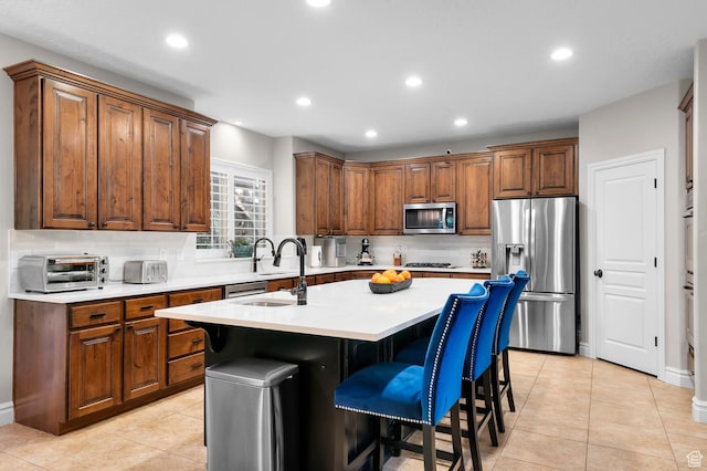 292 E Clubview Ln, Lehi, UT 84043 - kitchen featuring appliances with stainless steel finishes, tasteful backsplash, a kitchen island with sink, light countertops, and recessed lighting
