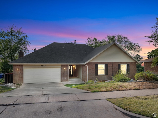 4525 S Taylor Ave E, Ogden, UT 84403 - single story home featuring driveway, brick siding, an attached garage, and a chimney