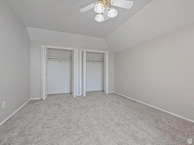 4525 S Taylor Ave E, Ogden, UT 84403 - unfurnished bedroom with multiple closets, light carpet, lofted ceiling, and ceiling fan