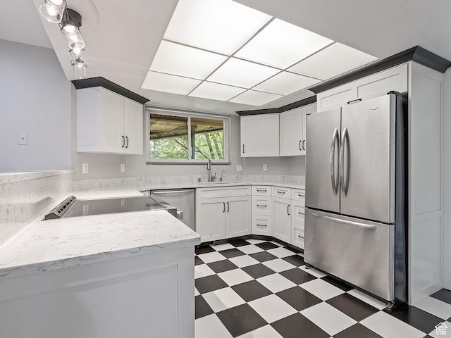 4525 S Taylor Ave E, Ogden, UT 84403 - kitchen featuring stainless steel appliances, tile patterned floors, white cabinets, and light stone countertops