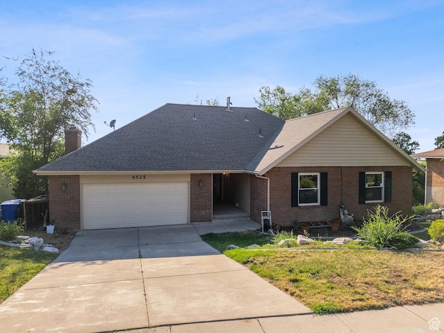 4525 S Taylor Ave E, Ogden, UT 84403 - ranch-style home featuring brick siding, driveway, an attached garage, and a chimney