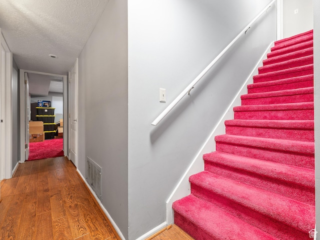 4525 S Taylor Ave E, Ogden, UT 84403 - stairs with a textured ceiling and wood finished floors