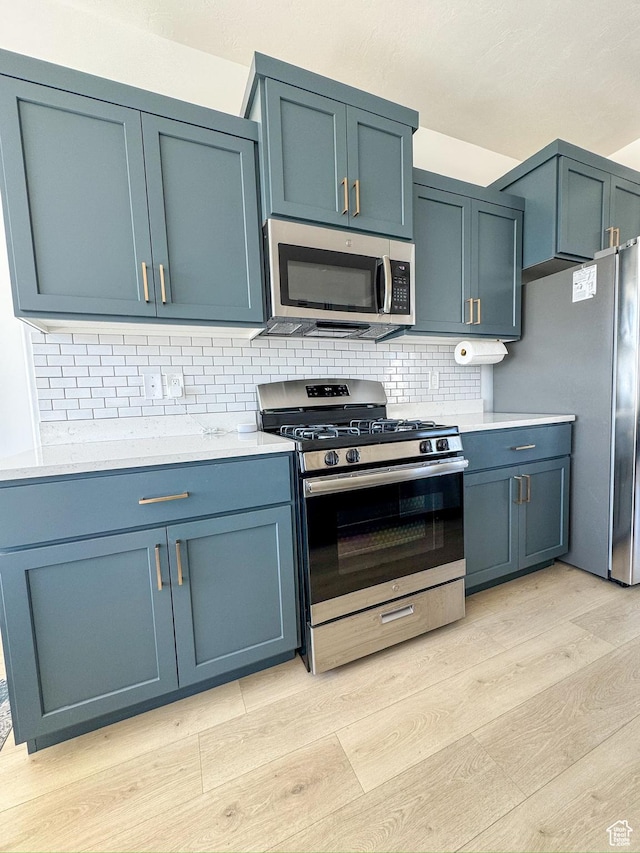 457 S Wood Stream Rd, American Fork, UT 84003 - kitchen with stainless steel appliances, light wood-type flooring, tasteful backsplash, and light countertops